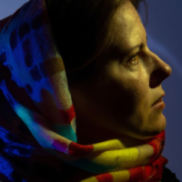 dark and beautiful photos of a young woman in a colurful scarf, in the style of daan roosegaarde, religious subjects, mikhail nesterov, contemporary take on medieval art, forestpunk, webcam photography, linnea strid, scar on left cheek, not looking directly at camera