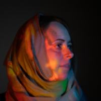 dark and beautiful photos of a young woman in a colurful scarf, in the style of daan roosegaarde, religious subjects, mikhail nesterov, contemporary take on medieval art, forestpunk, webcam photography, linnea strid, scar on left cheek, not looking directly at camera